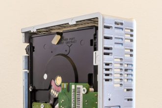 A monitor displays a cloud server network diagram with connected nodes and data routes.