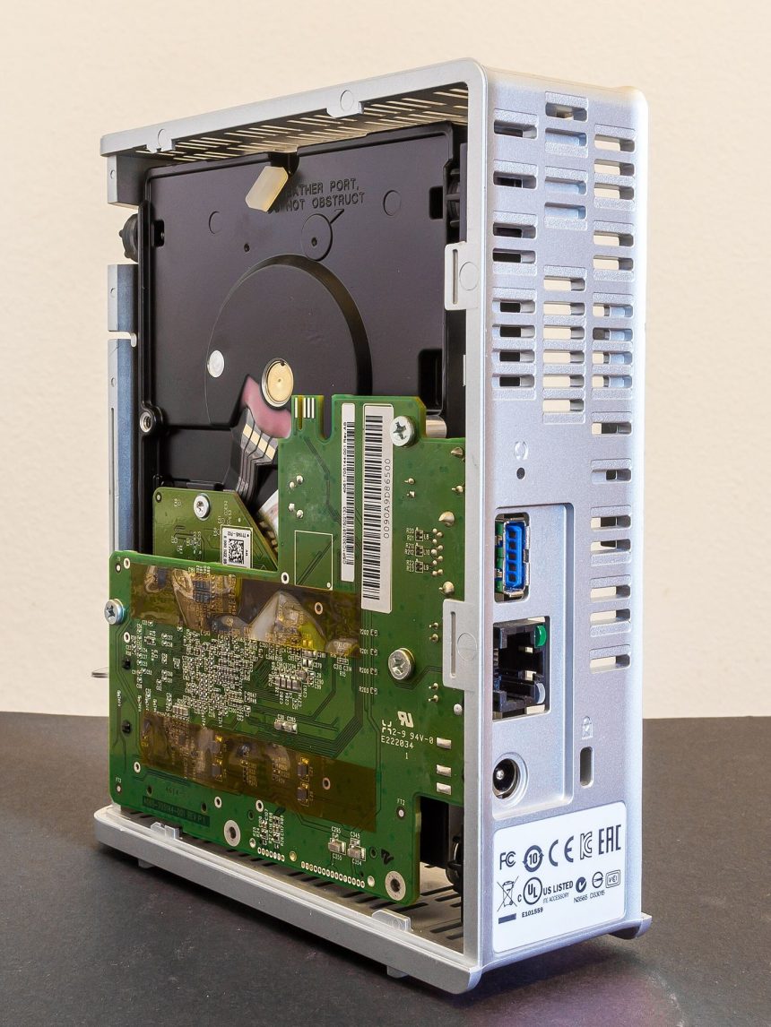 A monitor displays a cloud server network diagram with connected nodes and data routes.