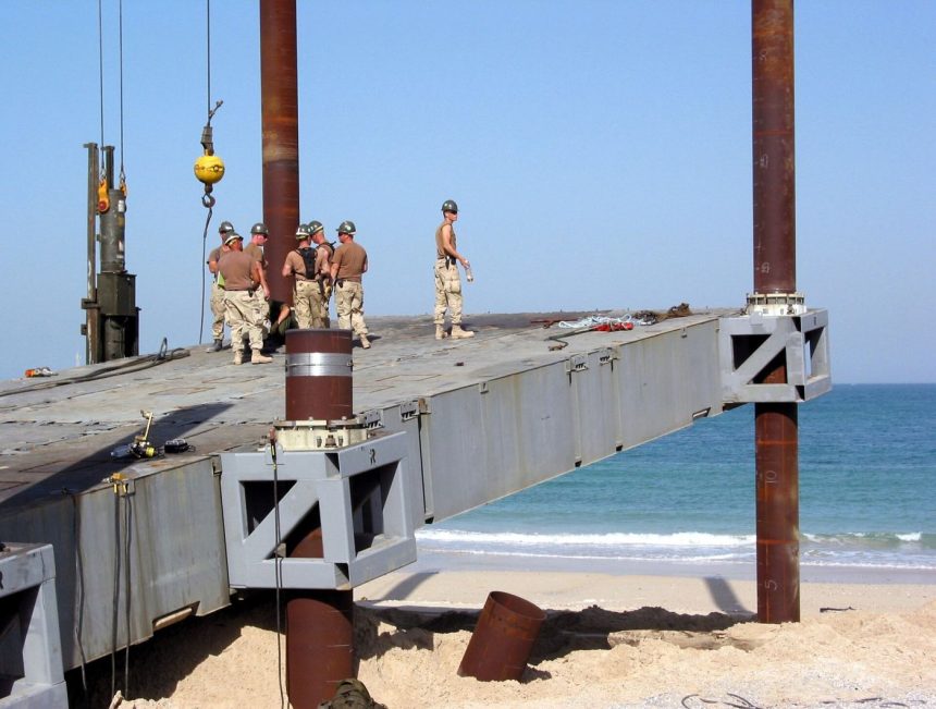 A crane lowering a prefabricated building module into place on a construction site